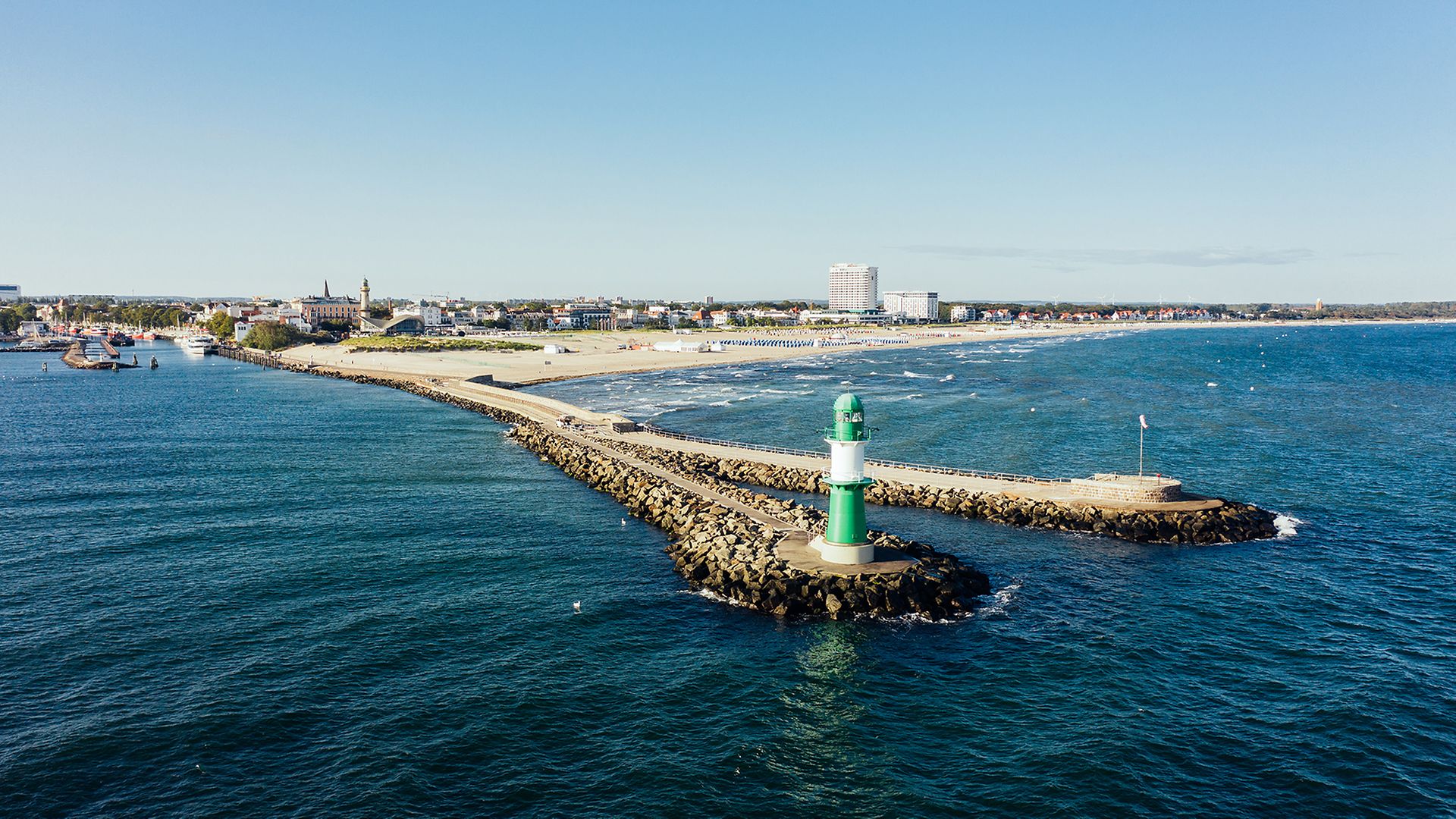 Blick von oben auf den Leuchtturm an der Mole in Warnemünde